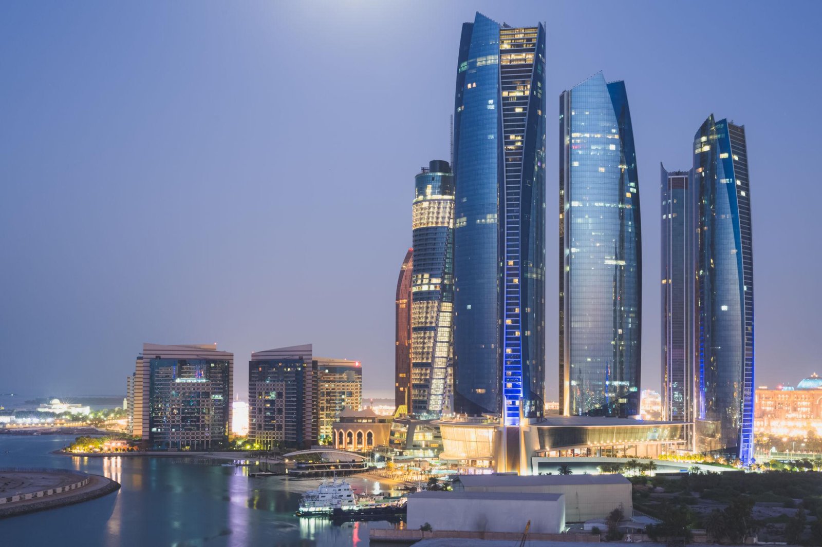 Abu Dhabi skyline at night with modern skyscrapers and city lights in UAE